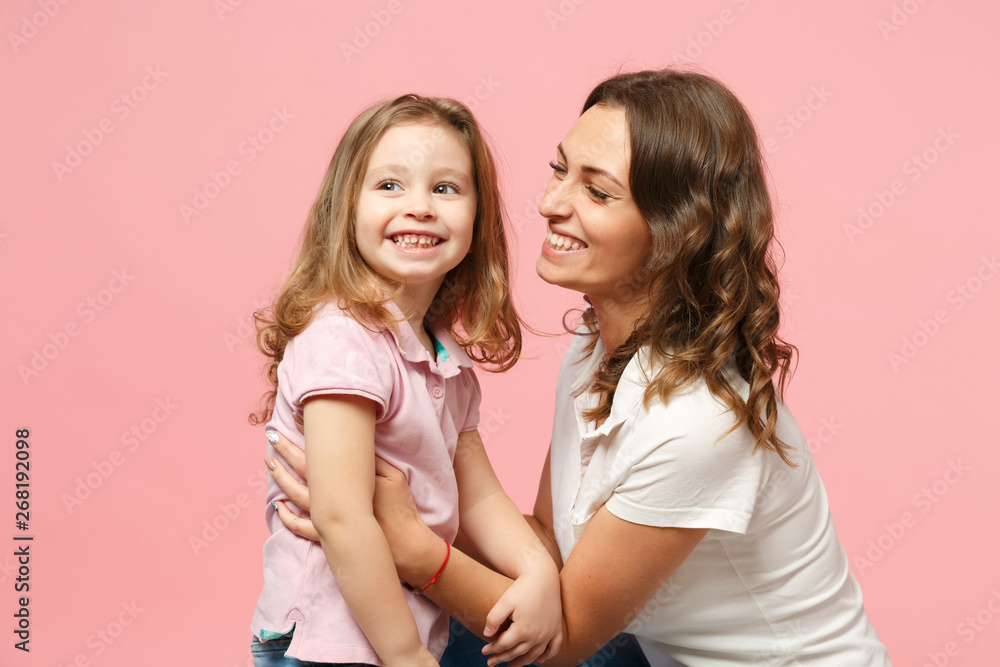 Woman in light clothes have fun with cute child baby girl. Mother, little kid daughter isolated on pastel pink wall background, studio portrait. Mother's Day, love family, parenthood childhood concept Woman in light clothes have fun with cute child baby girl. Mother, little kid daughter isolated on pastel pink wall background, studio portrait. Mother's Day, love family, parenthood childhood concept