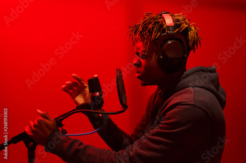 Side view black man singing in studio