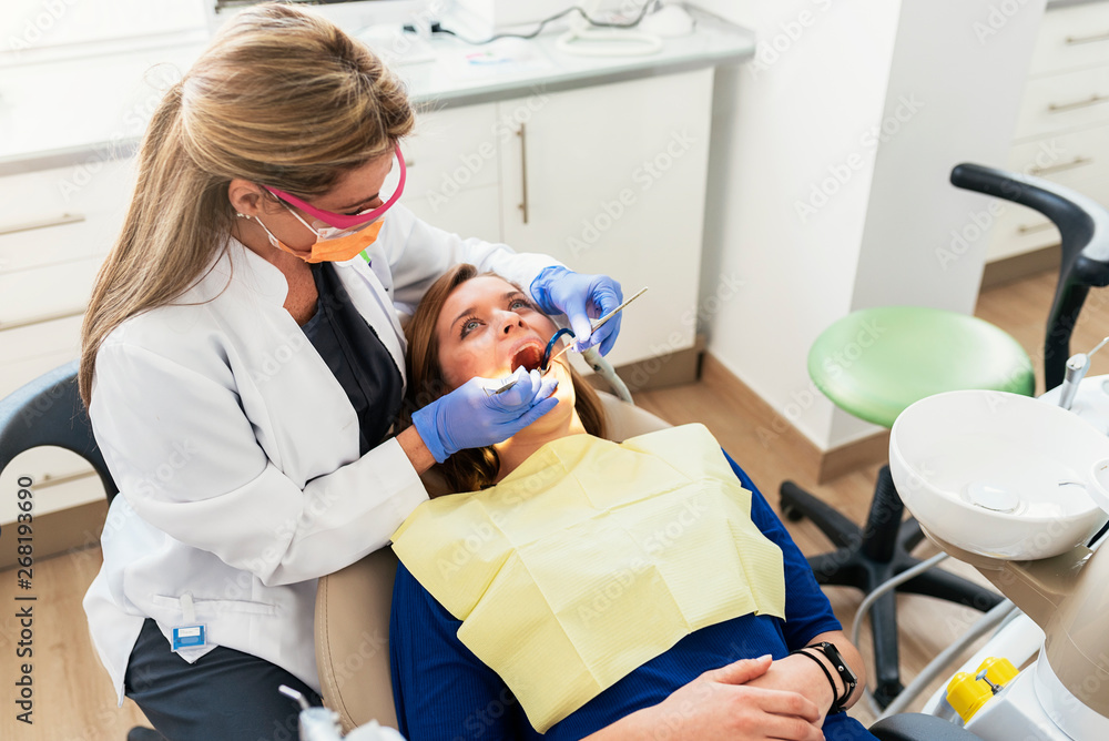Dentist during a dental intervention with a patient. Dentist during a dental intervention with a patient.