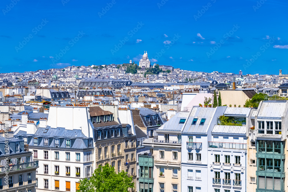 Paris, typical roofs in the Marais, aerial view with the Sacre-Coeur basilica 