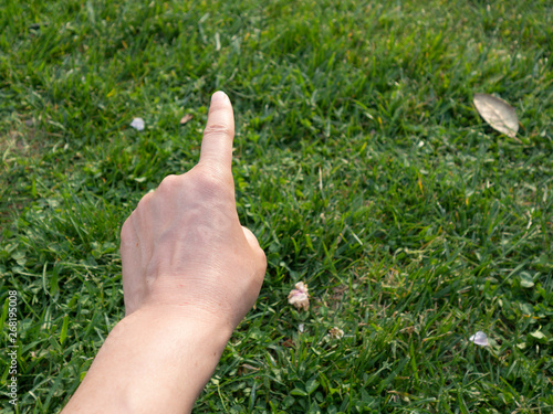 male hand on the grass © engin