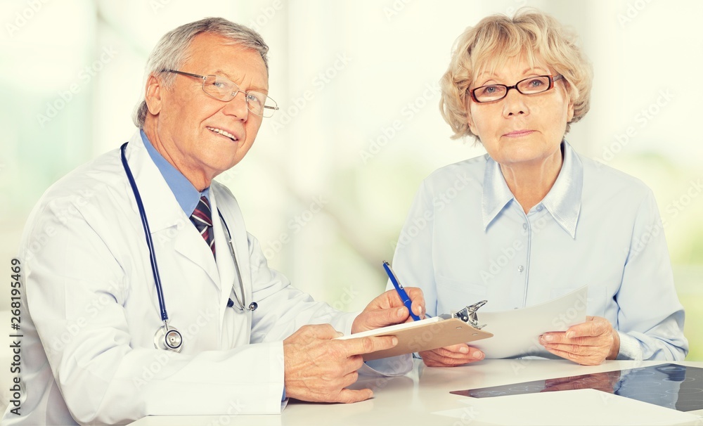 Female senior patient visiting a doctor at the medical office Female senior patient visiting a doctor at the medical office