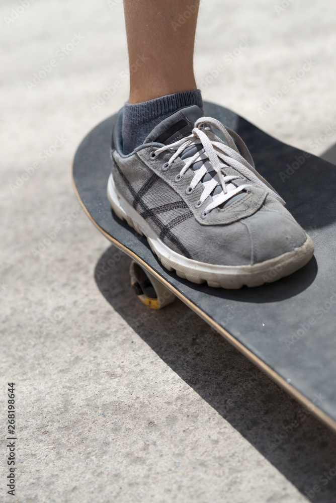 Close up of a young skateboarder shoe riding on skateboard