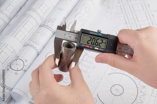 Precise measurement of metal part. Measuring with electronic digital caliper	 photo