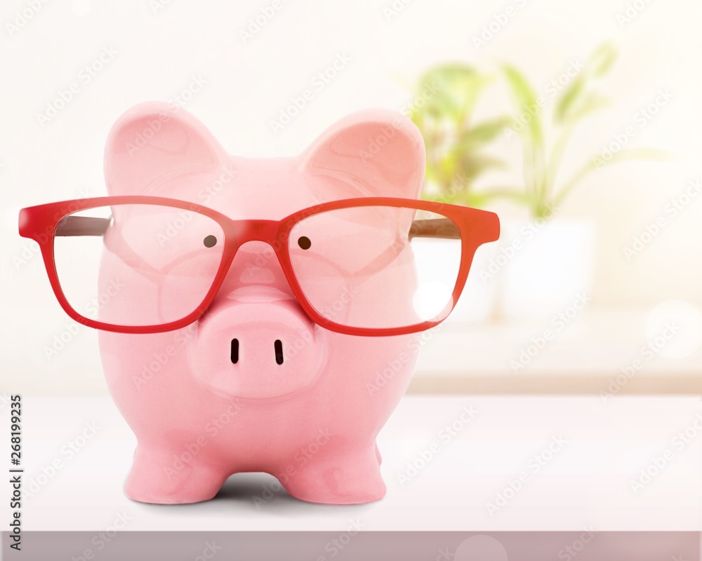 Piggy bank in red glasses on white background Piggy bank in red glasses on white background