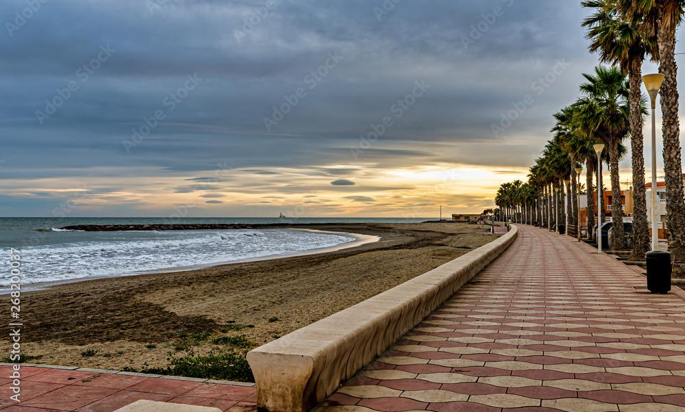 Sunset view of beach promenade in Costacabana, on the Mediterranean coast of Almeria, Spain. Sunset view of beach promenade in Costacabana, on the Mediterranean coast of Almeria, Spain.