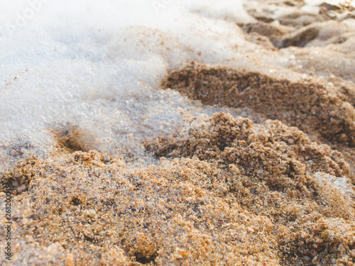 Closeup image of foam and suds on the sand at sea beach. Abstract background. © Кирилл Рыжов