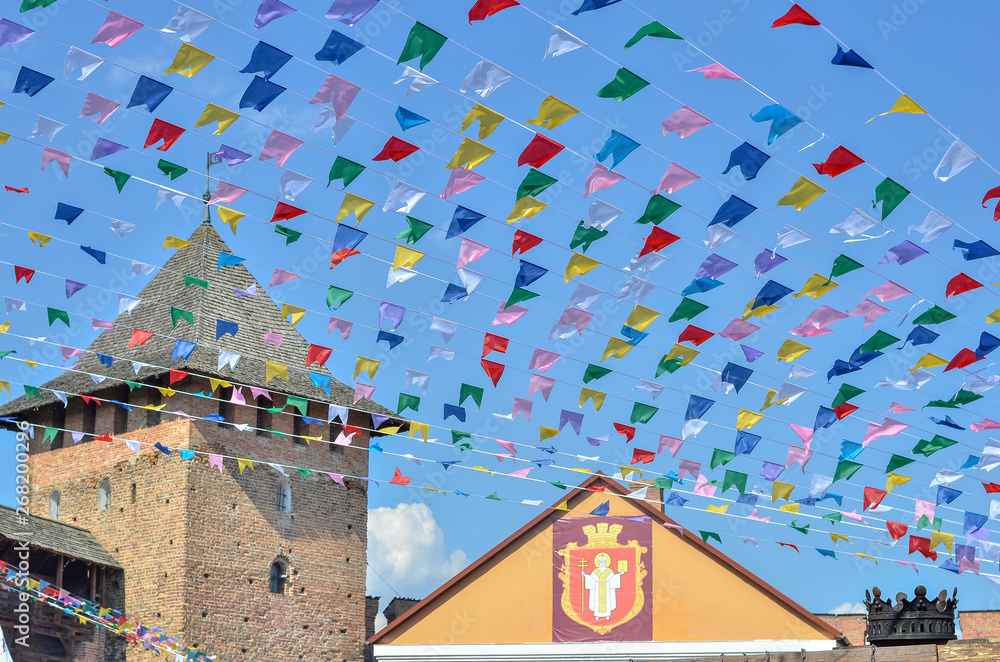 Castle decorated with colorful flags at festival.