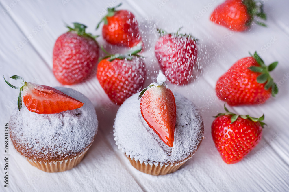 strawberry muffins on a white table, powdered on them, top view strawberry muffins on a white table, powdered on them, top view