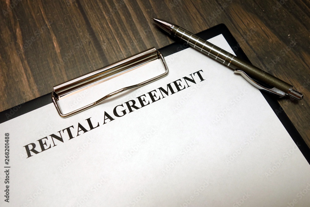Clipboard with rental agreement mockup and pen on desk