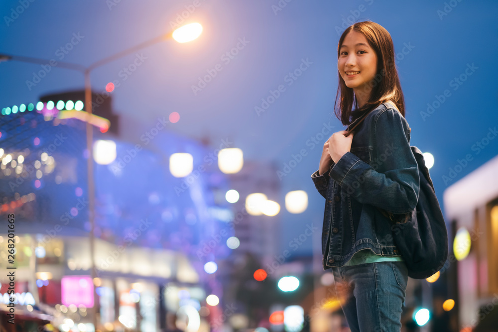 Young traveller woman walking on city street at night. Young traveller woman walking on city street at night.