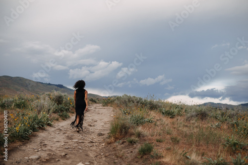 Woman Walking Away Down Trail photo