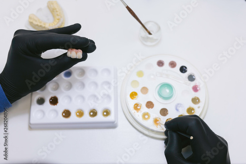 Dental technician making new teeth photo