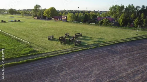 A Few Horse Obstacles staying on a green grass area - German Countryside photo