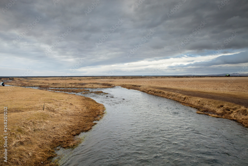 The Seljalands River flows into the distant horizon The Seljalands River flows into the distant horizon