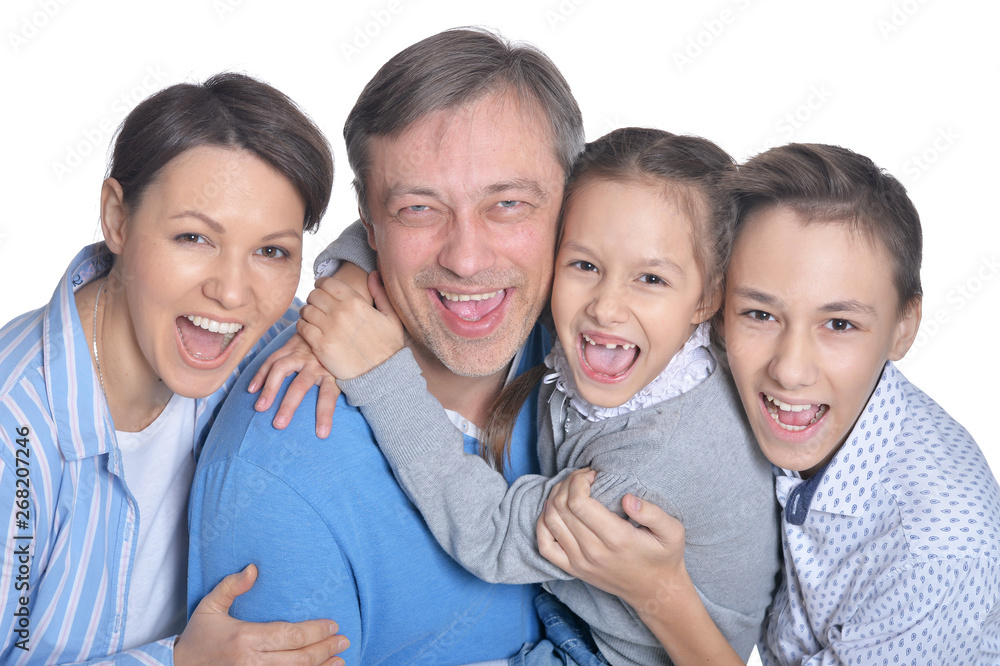 Happy smiling family of four posing on white background Happy smiling family of four posing on white background