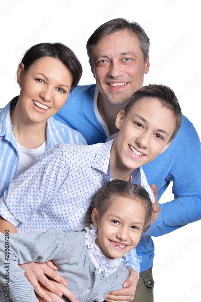 Happy smiling family of four posing on white background Happy smiling family of four posing on white background