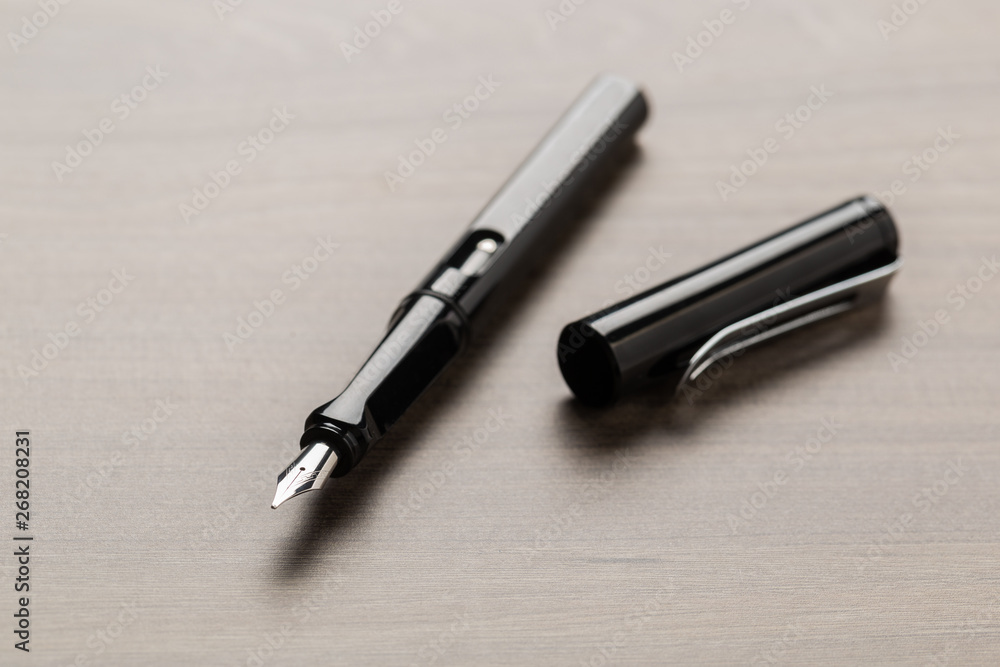 Black fountain pen on table Black fountain pen on table