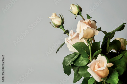 bouquet of light pink roses on the wall with plaster decorative elements