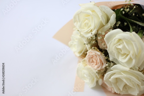 wedding bouquet of light pastel roses on a white background with a place for an inscription