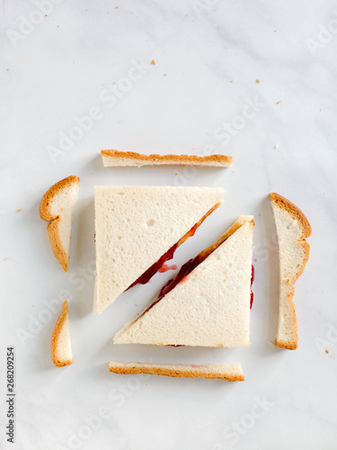 Sliced peanut butter and jelly sandwich with crusts cut off