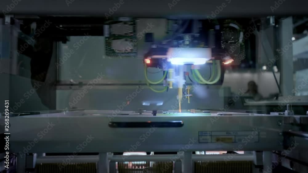 Factory Machine at Work: Printed Circuit Board Being Assembled with Automated Robotic Arm, Surface Mounted Technology Connecting Microchips to the Motherboard. Time Lapse Macro Close-up Footage Factory Machine at Work: Printed Circuit Board Being Assembled with Automated Robotic Arm, Surface Mounted Technology Connecting Microchips to the Motherboard. Time Lapse Macro Close-up Footage