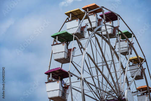Colorful ferris wheel in blue sky background. Copy Space