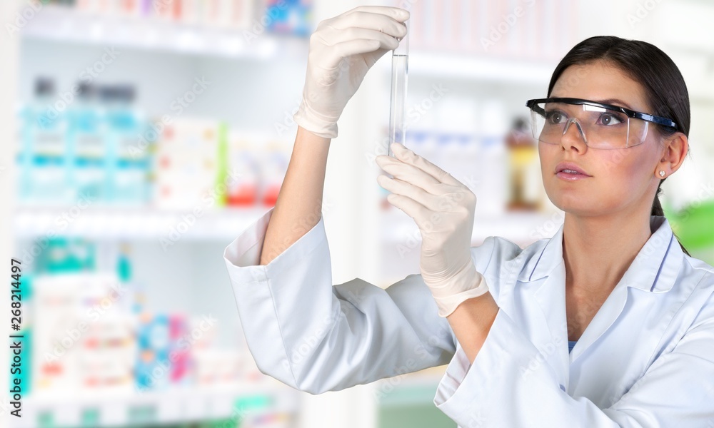 Young female scientist standing in her lab. Young female scientist standing in her lab.