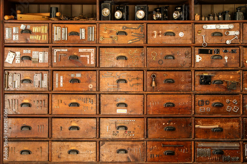 A detail of an old cupboard with drawers, part of the old vintage ironmongery. 