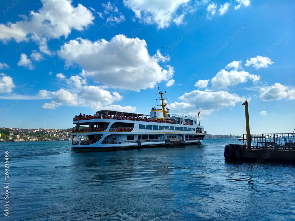steamboat and seascape under clear sky and cloud clusters in bosporus