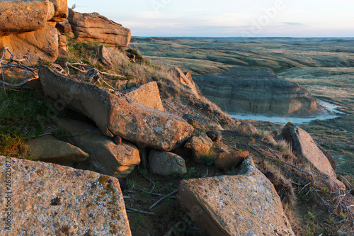 View of lichen-covered rocks and badlands at dusk, Grasslands National Park, Saskatchewan, Canada