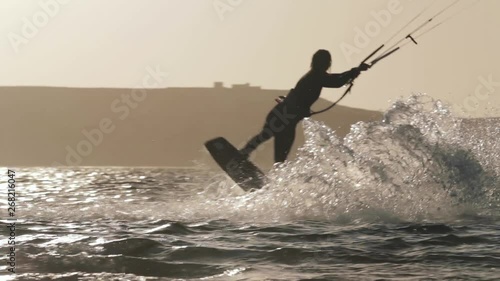 Silhouette of Girl Kitesurfing at Sunset