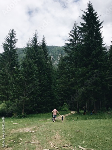 A father and son walking in a forest photo