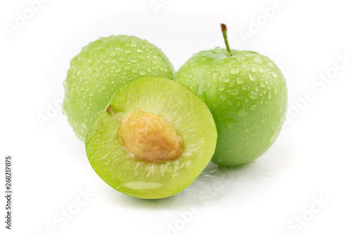 fresh and green plum on white background photo