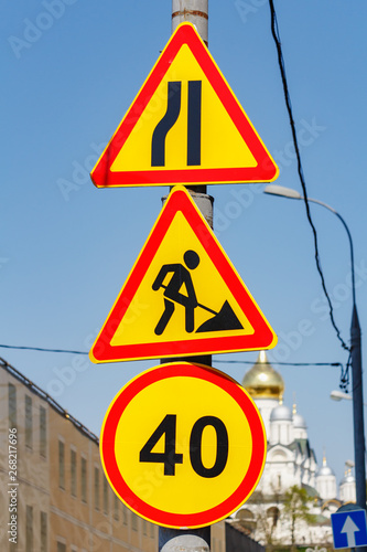 Road signs Road repairs and Speed limit 40 closeup against blue sky on the city street