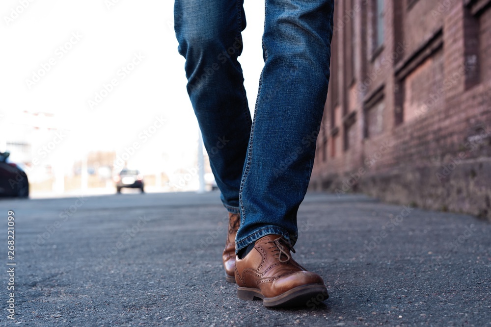 Male Legs In Jeans And Leather Boots Outdoor. Fashion Street Photo, color tone Male Legs In Jeans And Leather Boots Outdoor. Fashion Street Photo, color tone