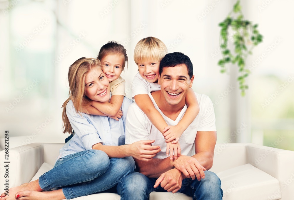 Beautiful smiling family sitting at sofa at Beautiful smiling family sitting at sofa at