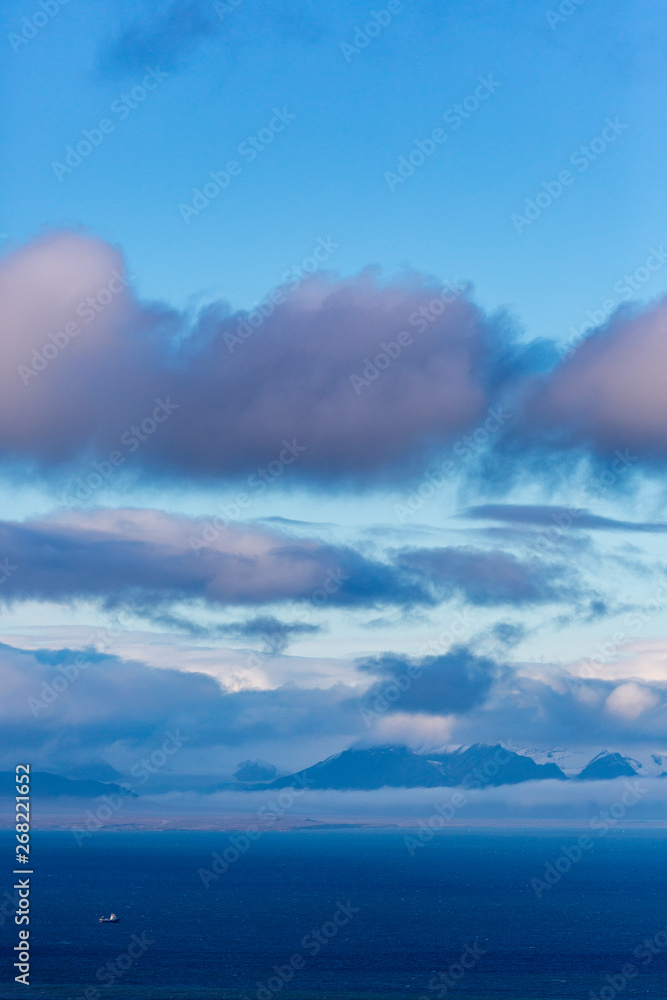 Obraz premium View across Isfjord in Svalbard, Blue water with boat and glaciers in the background, Halfmoon, Svalbard, Spitsbergen, Norway