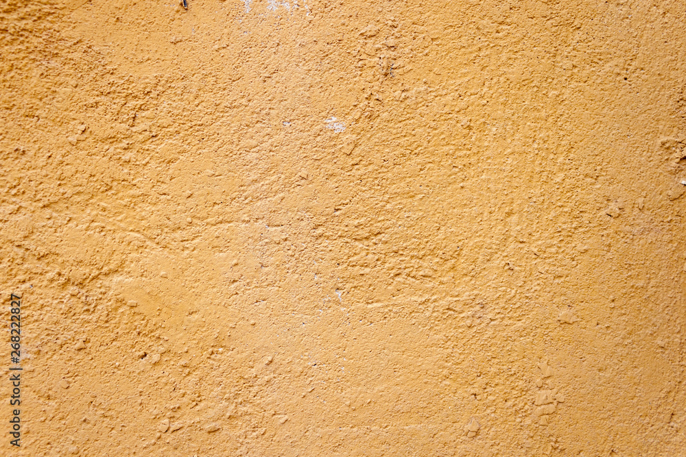 Background rough rustic shabby texture of old wall with yellow cracked plaster Background rough rustic shabby texture of old wall with yellow cracked plaster