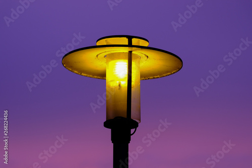shining street lamp in the evening sky