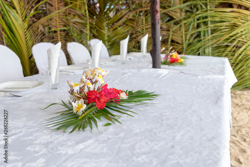 Set table with flowers on a beautiful beach