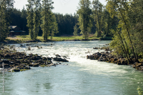 Mountain river in Oregon with cabin in the background