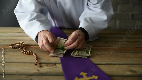Greedy catholic priest counting money
