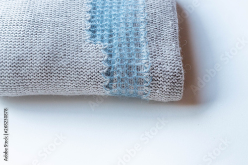 Wool sweater, blue and beige background, blurred texture