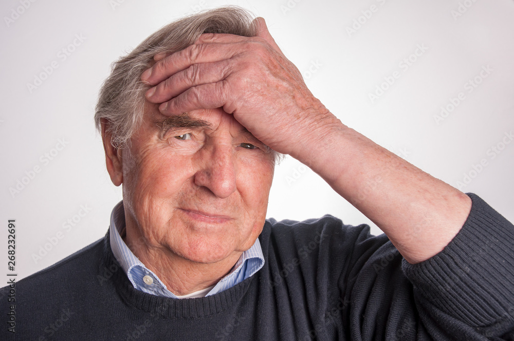 Senior man with headache isolated on white Senior man with headache isolated on white