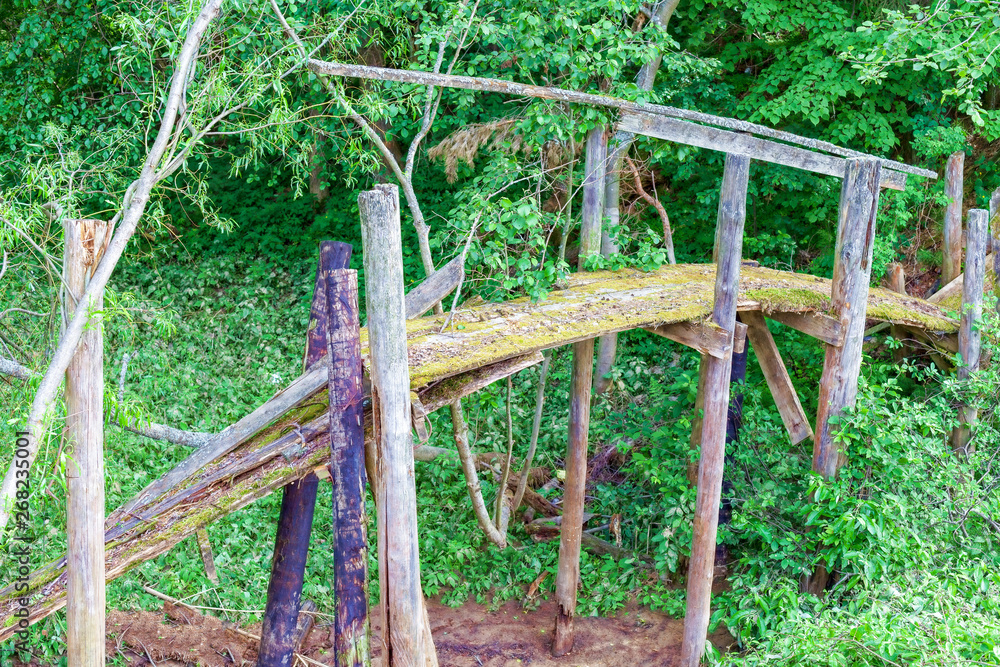 Fototapeta premium Old wooden bridge over the creek.