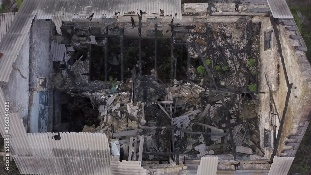 Aerial view. Old ruined building. Abandoned house. Dismantling the building structure. Demolition of the ruins on the outskirts of the city Aerial view. Old ruined building. Abandoned house. Dismantling the building structure. Demolition of the ruins on the outskirts of the city