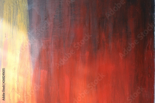 Multi-colored paint on a rusty metal door surface. As a textured authentic background for your project