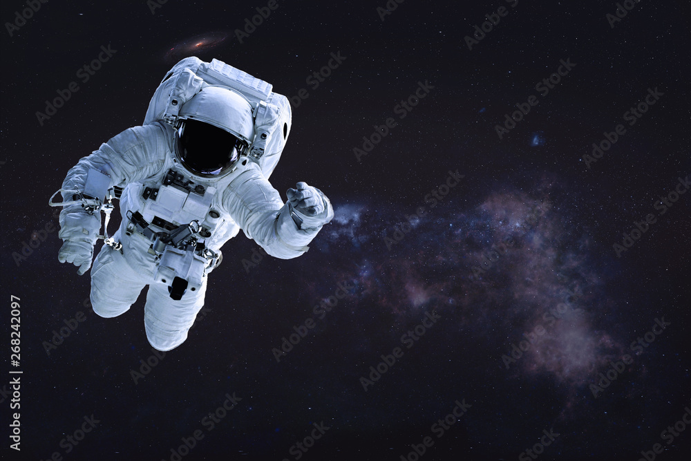 Naklejka premium Alone single Astronaut in outer space. Science fiction wallpaper. Elements of this image were furnished by NASA.