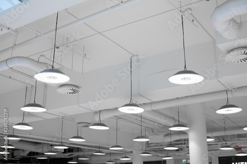 Shopping center led lighting. Ceiling lights in the mall. Ventilation and water pipes. Fire alarm system